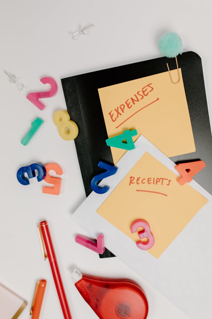 why-choose-us Flat lay of colorful office supplies and sticky notes labeled 'Expenses' and 'Receipts'.